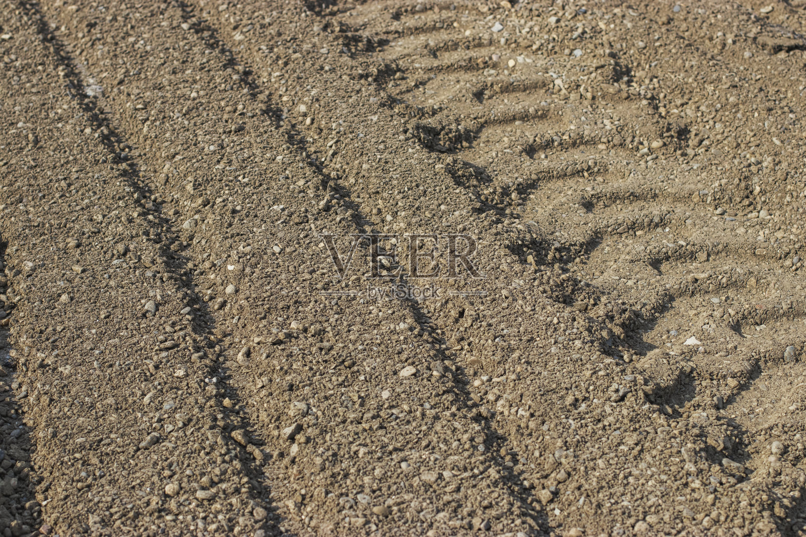 砂石上有施工机械车轮的痕迹。照片摄影图片