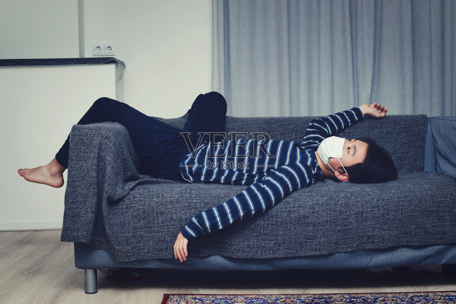 亚洲儿童戴口罩在家感到无聊(概念居家隔离)照片摄影图片