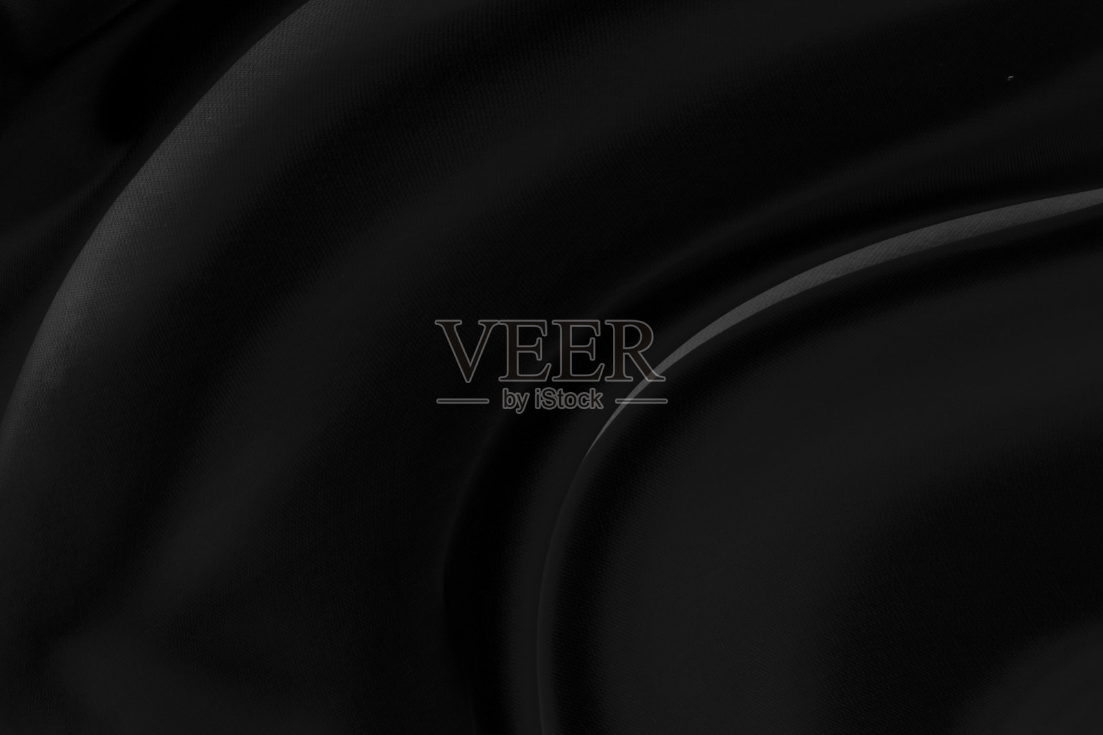 黑灰色的缎子，深色的织物，纹理豪华闪亮，抽象的丝绸布背景与图案，柔和的波浪模糊美丽。照片摄影图片