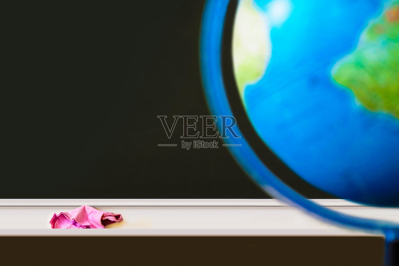 黑色的黑板，粉色的抹布和粉笔，抄写空间，地球仪。返校理念照片摄影图片