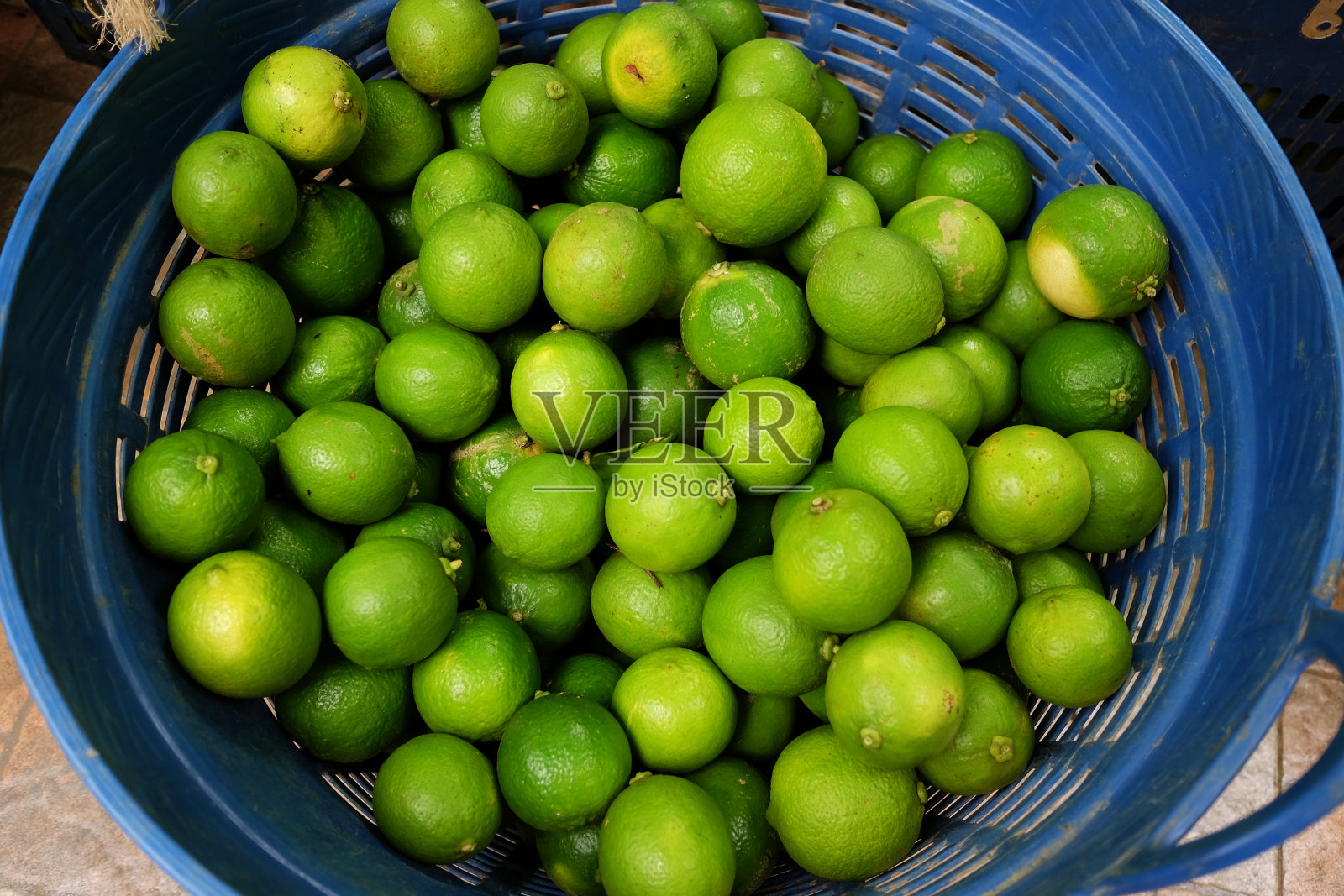 新鲜的柠檬产品储存在一个蓝色的篮子在泰国市场出售照片摄影图片