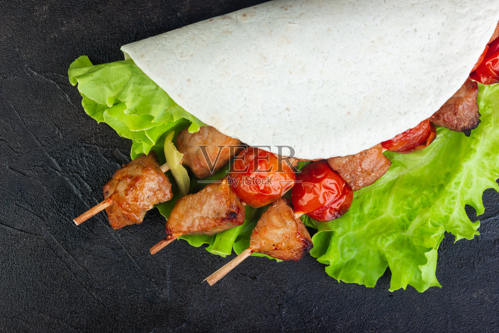 猪肉串、蔬菜、生菜和皮塔饼照片摄影图片