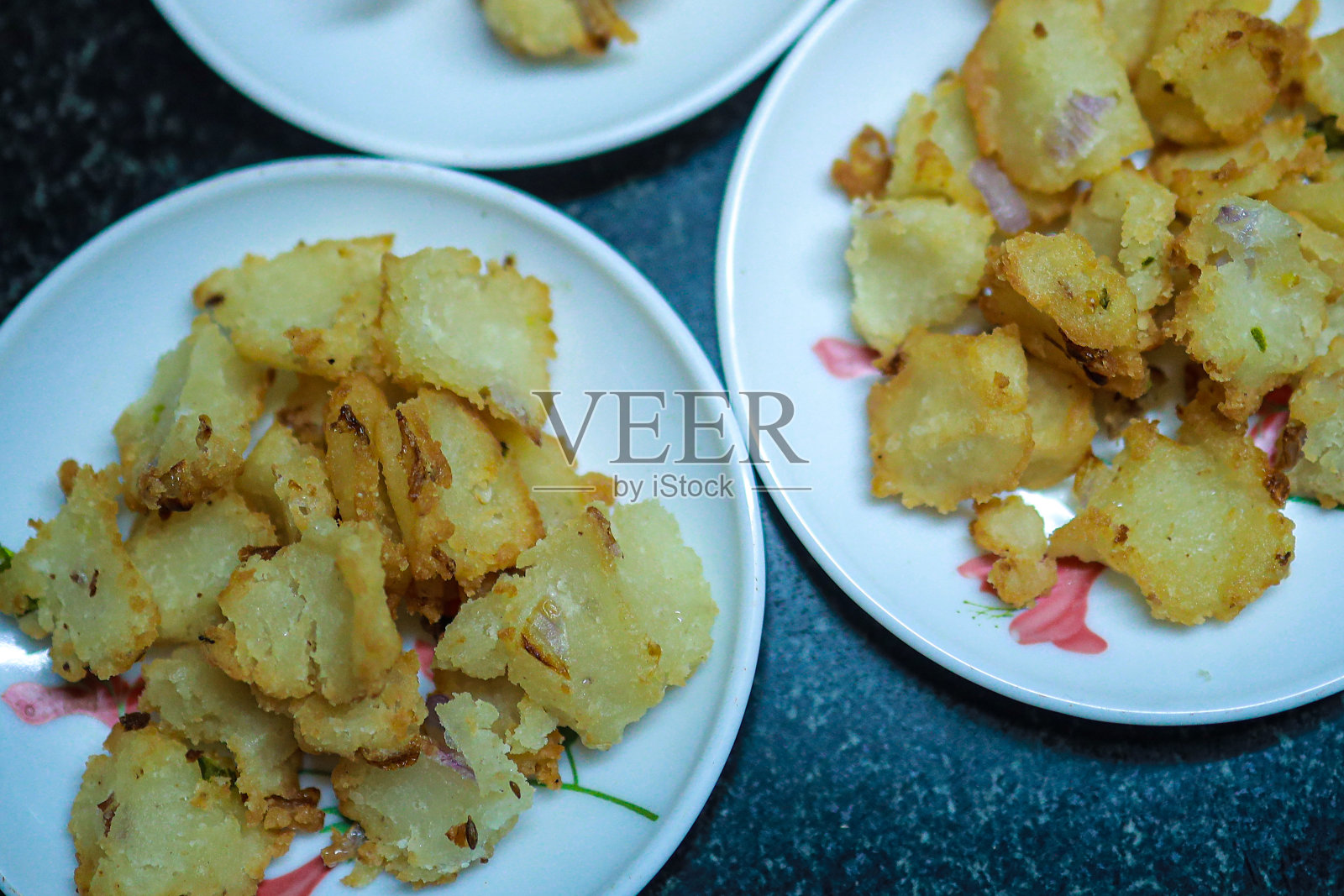 洋葱瓦达用热油在平底锅中煮沸近景，印度菜在传统的家庭制作方法中，这被一些地区称为瓦达。照片摄影图片