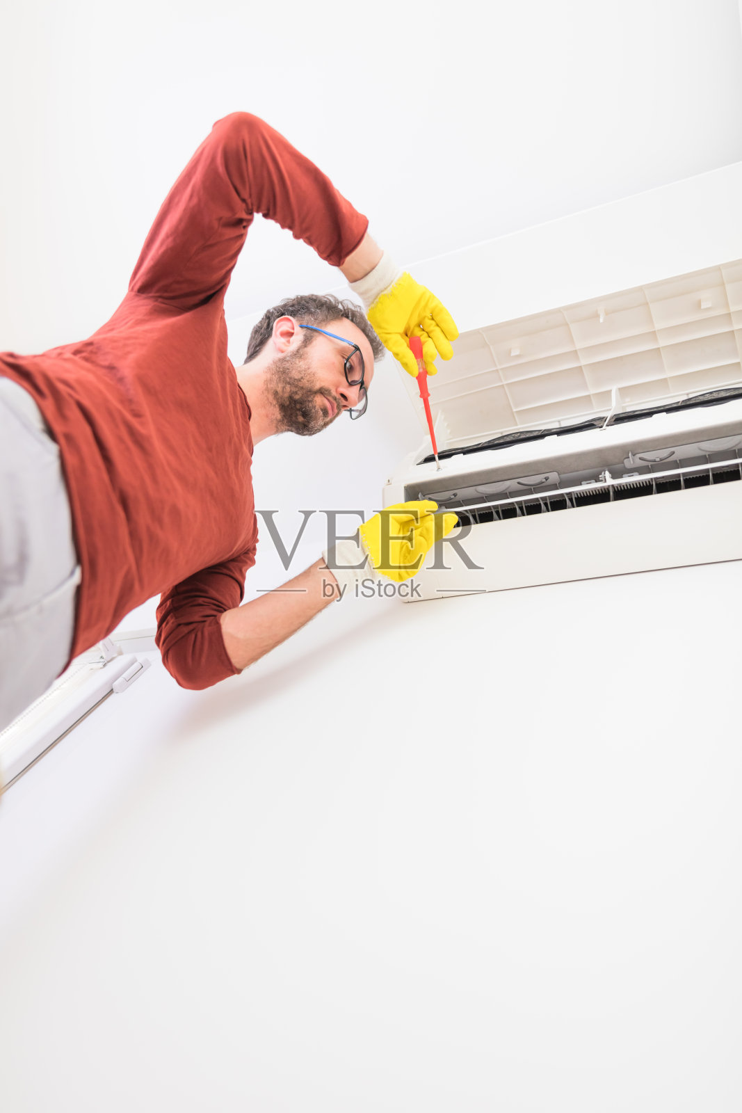 空调维修，固定空调机组，清洗/消毒过滤网，防止有害病原体侵入。照片摄影图片