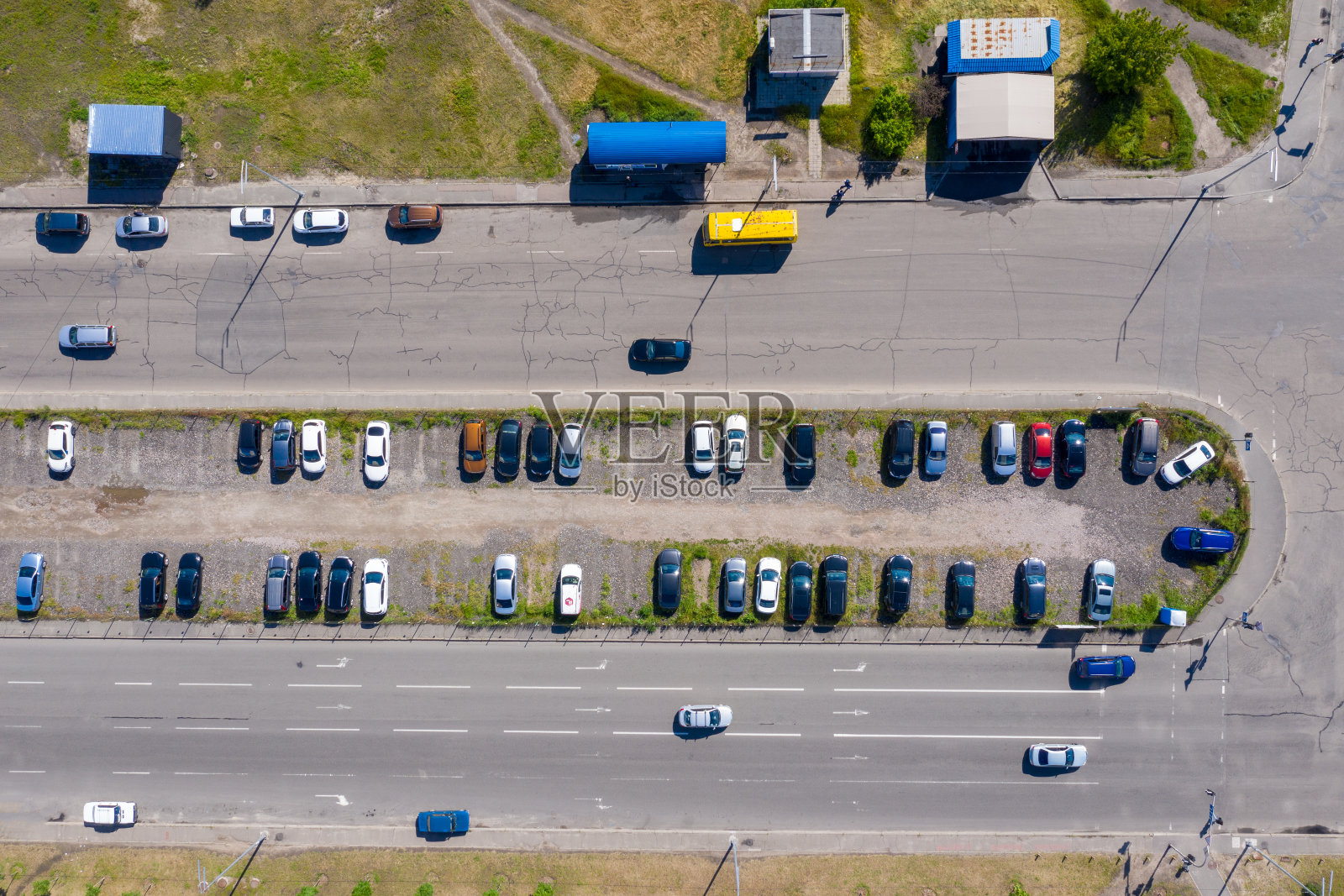 许多汽车停在城市郊区两条大道之间的一个自发的拦截停车场。航拍照片。照片摄影图片