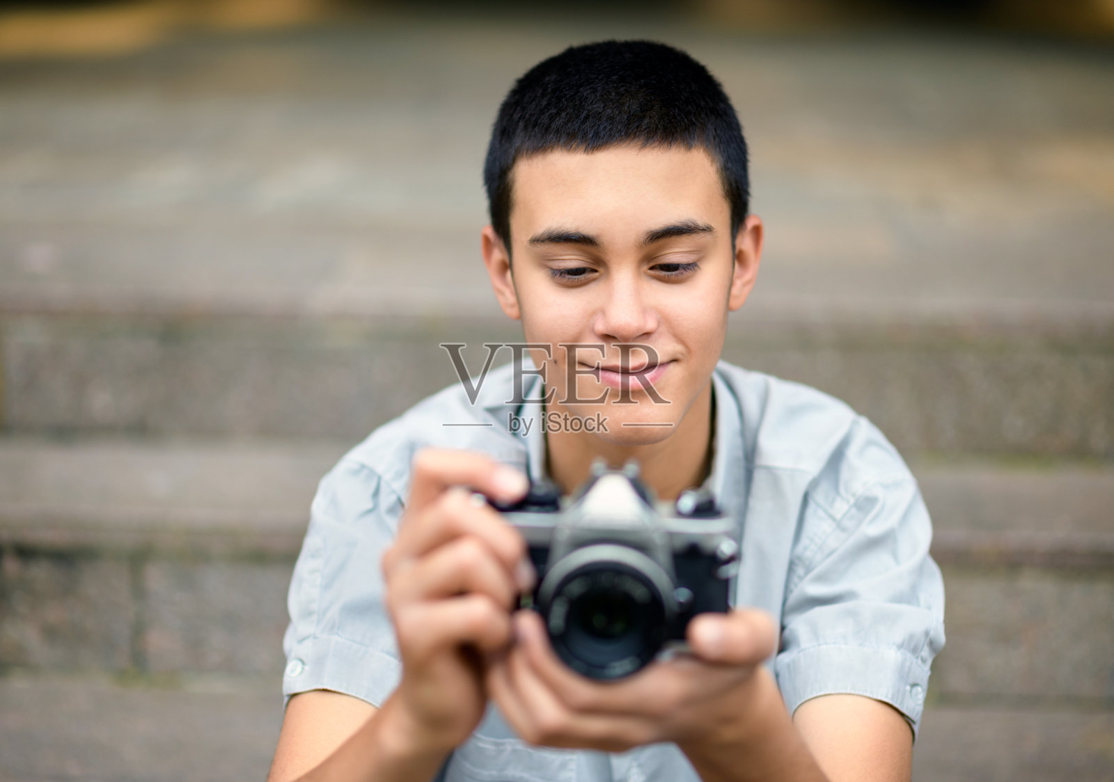 一个年轻人在看他相机上的照片照片摄影图片