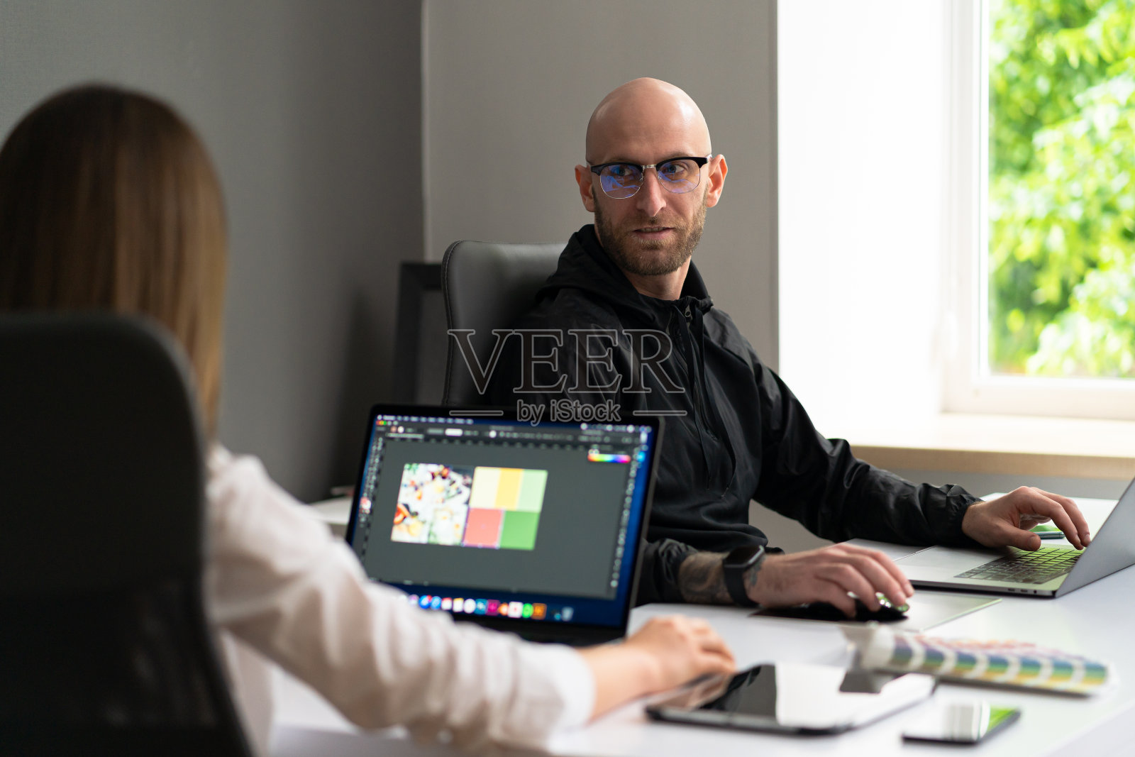 两个同事在办公室专注于笔记本电脑照片摄影图片