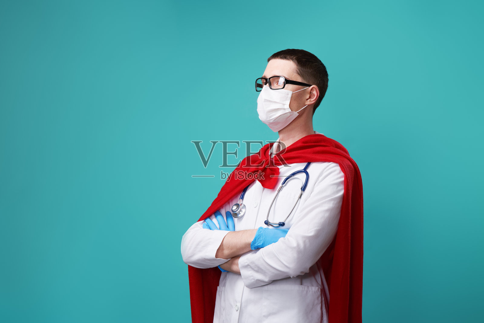 医生戴着外科口罩，穿着超级英雄斗篷。照片摄影图片