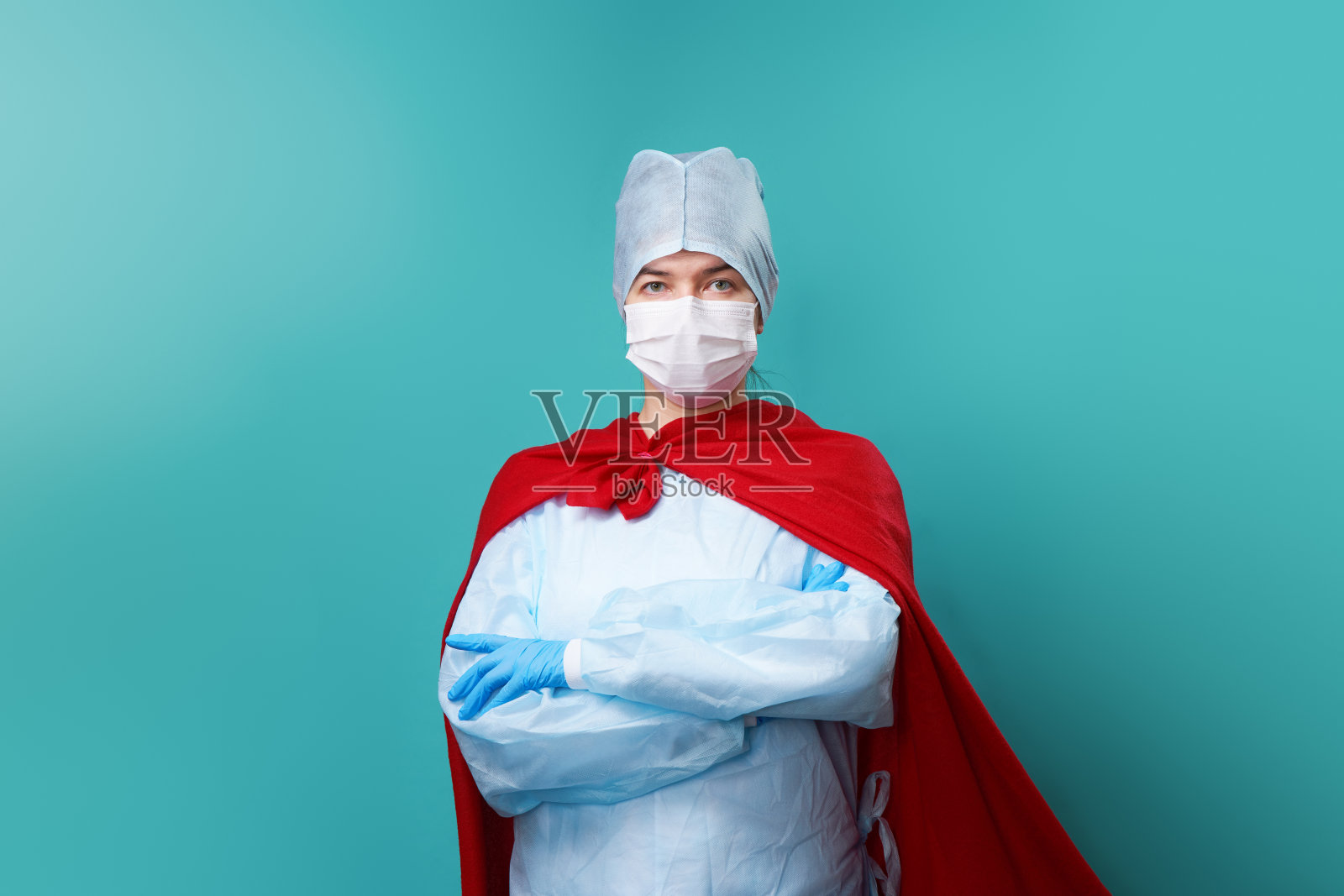 医生戴着外科口罩，穿着超级英雄斗篷。照片摄影图片