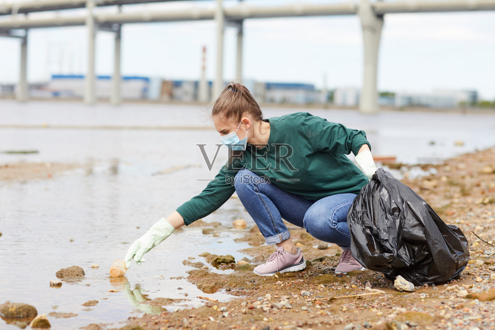 在城市里清理河流的女人照片摄影图片