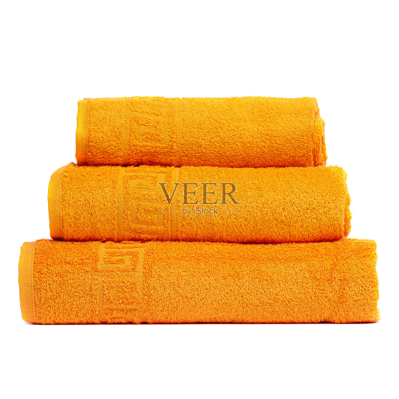 3 frotte毛巾橙色，卧室毛巾白色背景。彩色橙色浴巾孤立在白色。堆栈橙色毛巾。单独堆放彩色毛巾。三条相同颜色的棉质毛巾叠在一起照片摄影图片