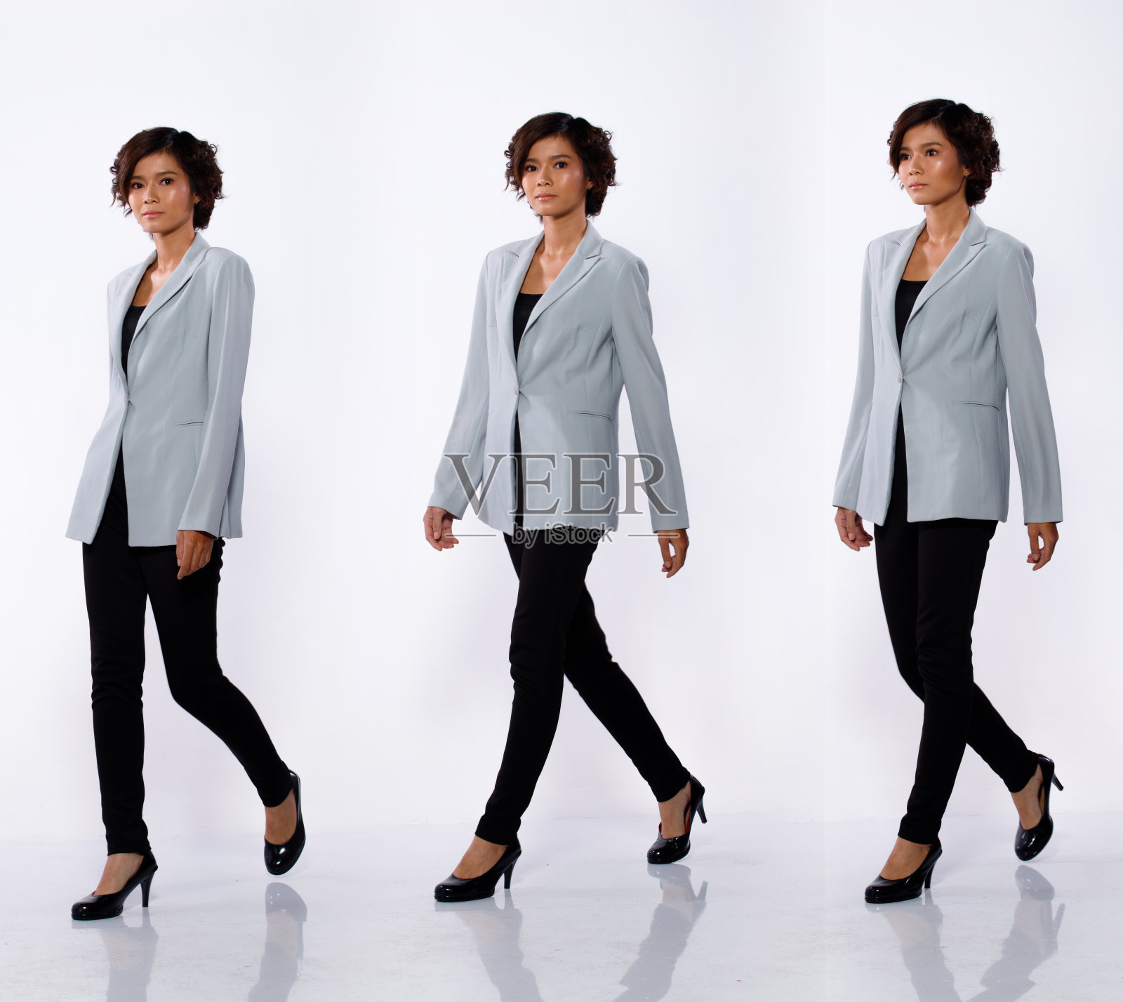 20岁亚洲女性黑色短卷发灰色西装夹克长裤轮廓照片摄影图片