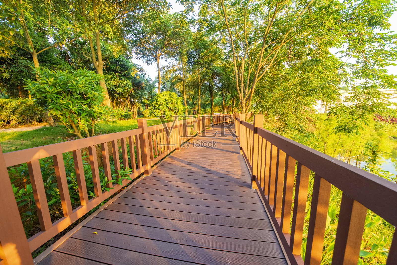 户外公园广场，日出和日落时有砖砌的人行道和木制的小路。照片摄影图片