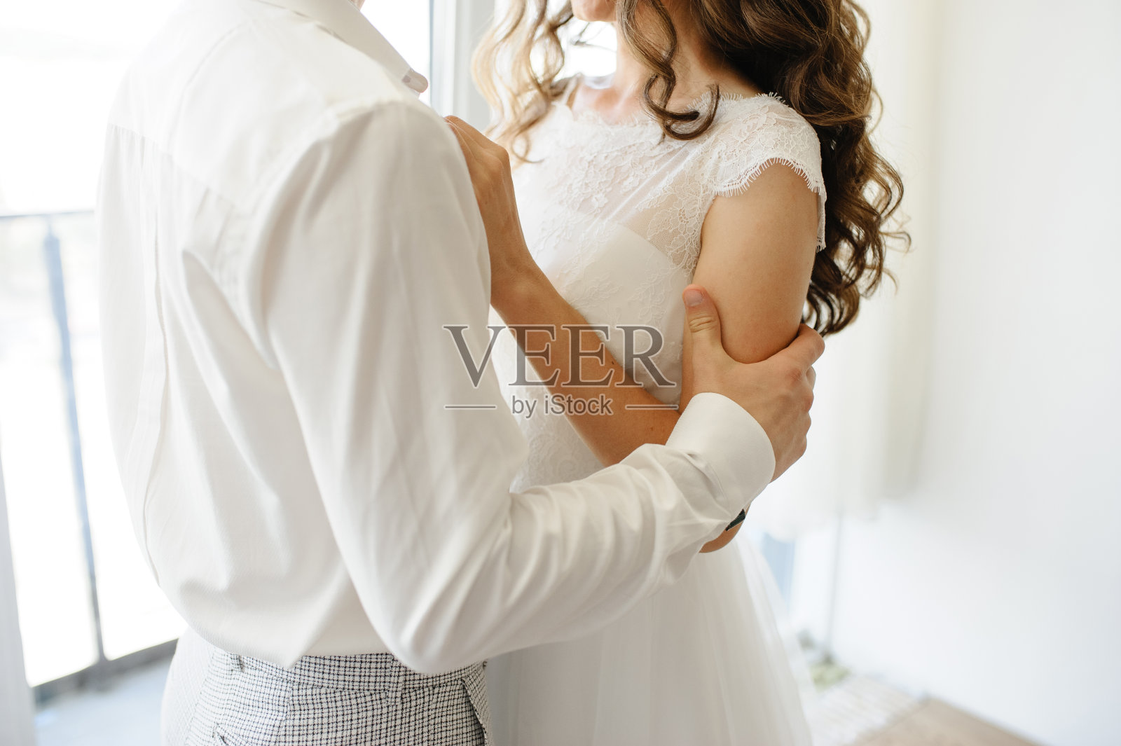 新郎抓住新娘的肩膀。特写镜头。照片摄影图片