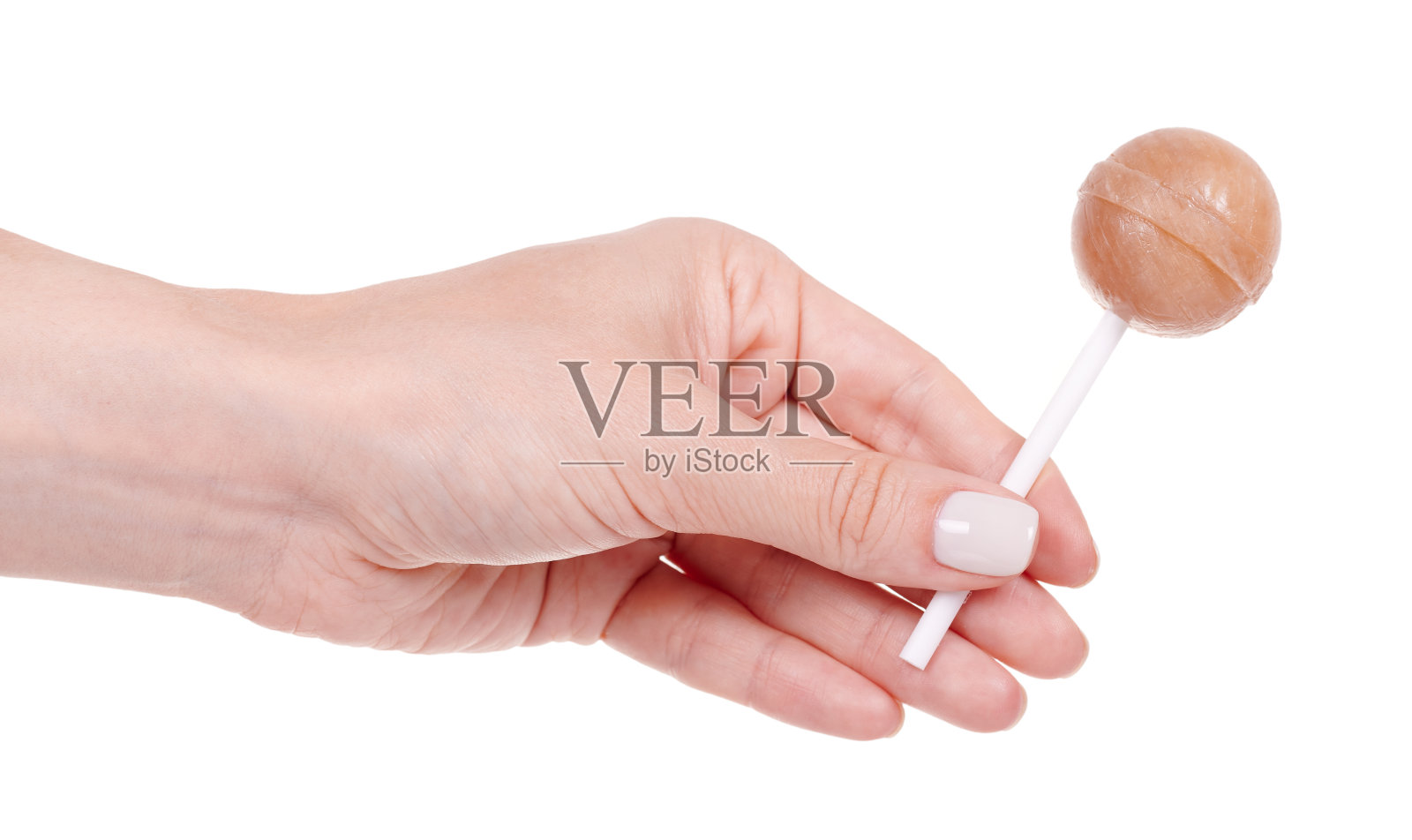 手握甜圆焦糖棒棒糖。孤立在白色背景上。照片摄影图片