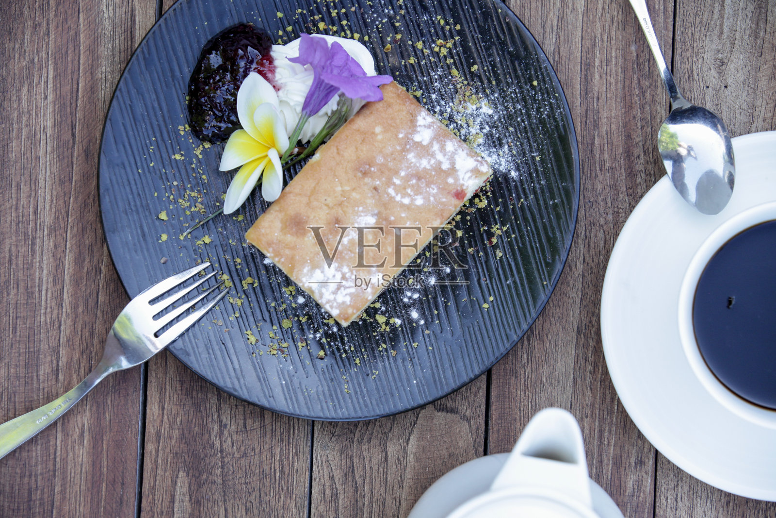 木桌上放着葡萄干面包，上面装饰着可食用的花朵照片摄影图片