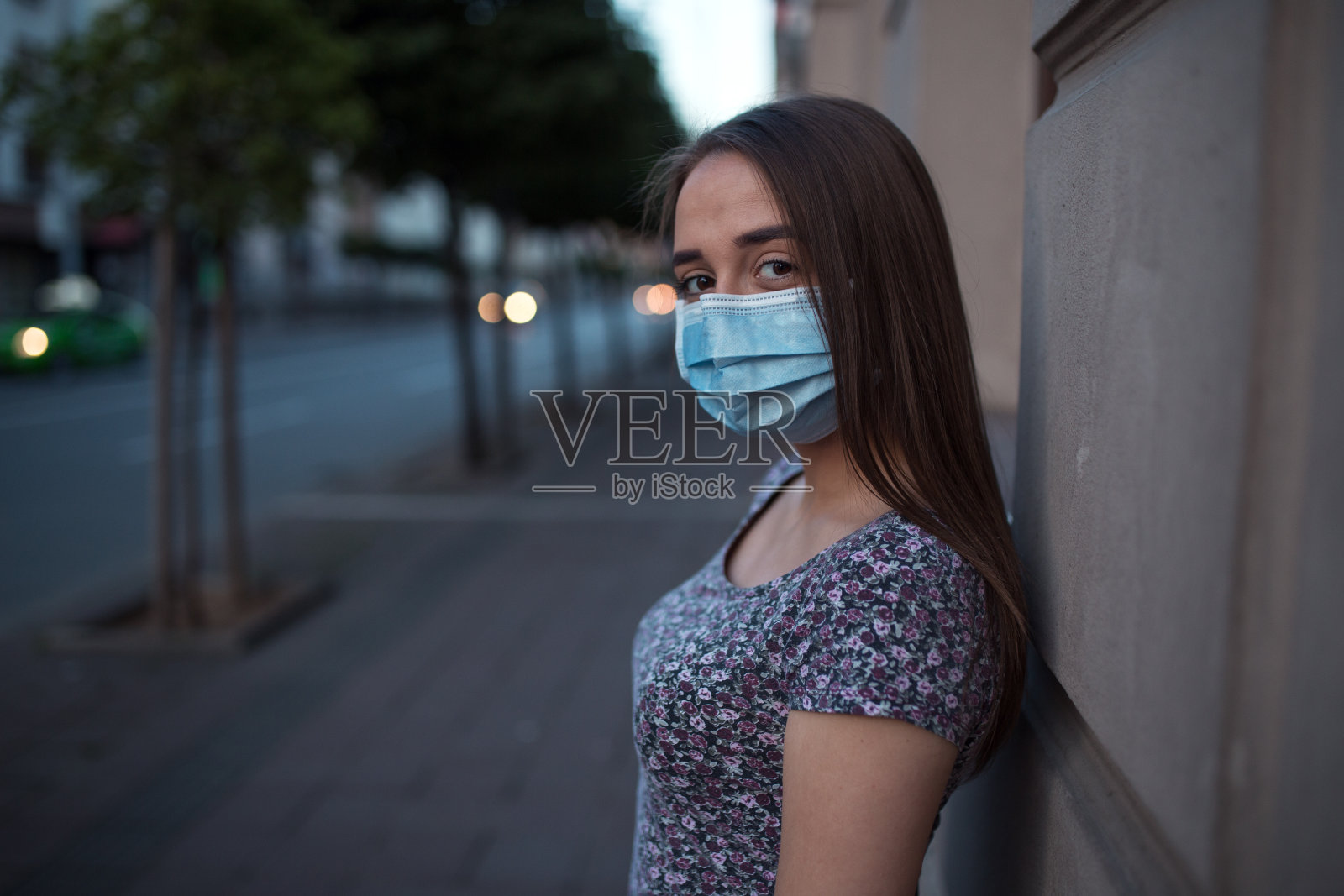 年轻妇女在疫情期间戴着防护口罩照片摄影图片