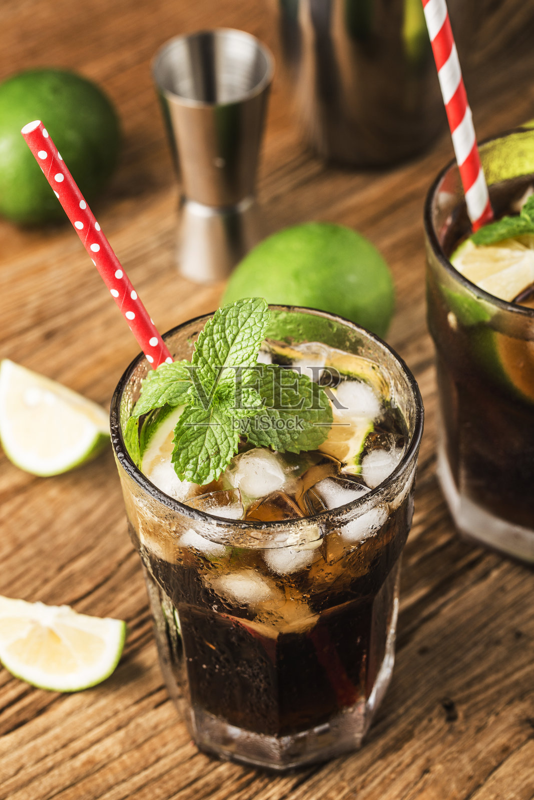 新鲜的古巴利布酒与棕色朗姆酒，可乐，薄荷和柠檬在木背景照片摄影图片