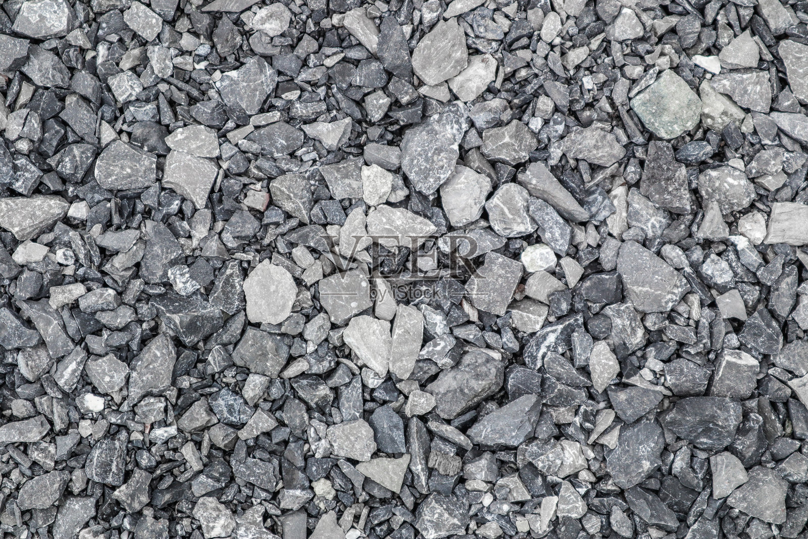 灰色的地面石，碎石的背景有许多小石块。照片摄影图片
