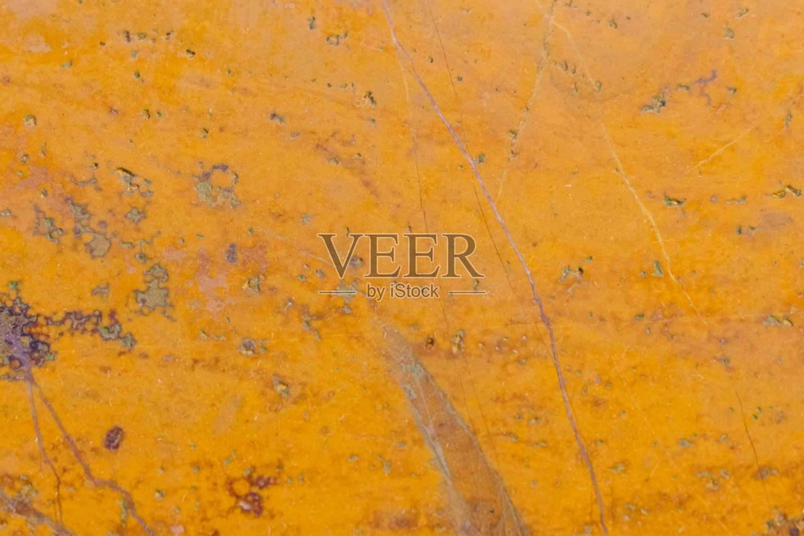 黄色抛光石材纹理，带有条纹和斑点。照片摄影图片
