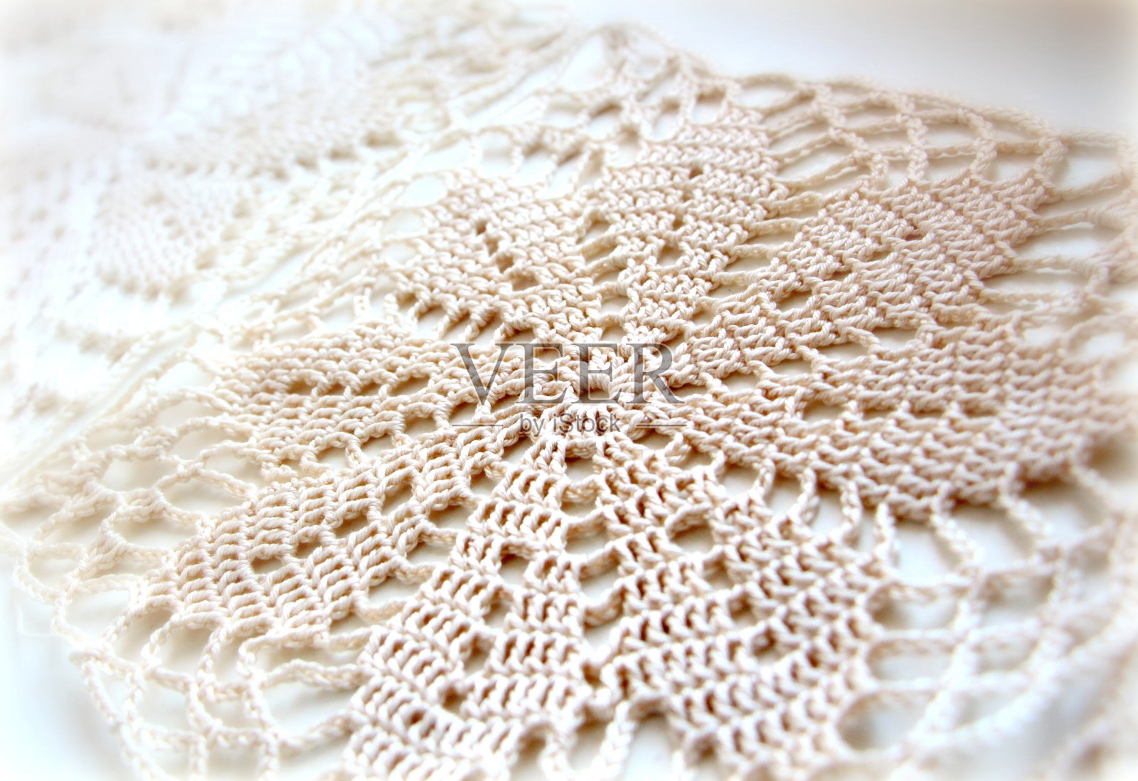 米色图案由棉和粘胶纱钩织而成。照片摄影图片