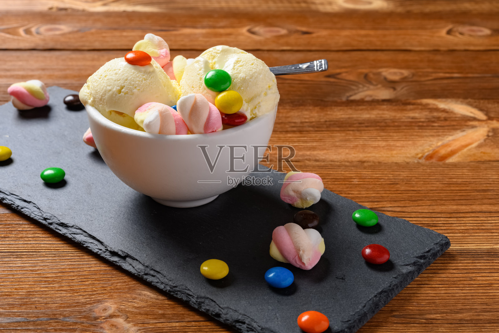 侧视图新鲜香草口味冰淇淋圣代与巧克力钮扣和棉花糖照片摄影图片
