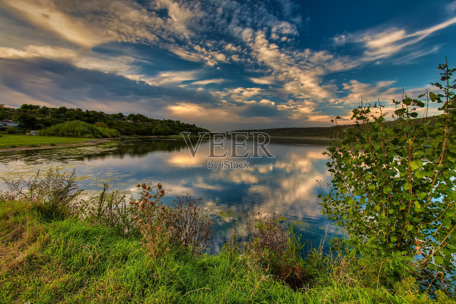 《河上的神奇日落》。五彩的天空在阳光下倒映在水面上。奇妙的自然背景，景色与戏剧性的天空照片摄影图片