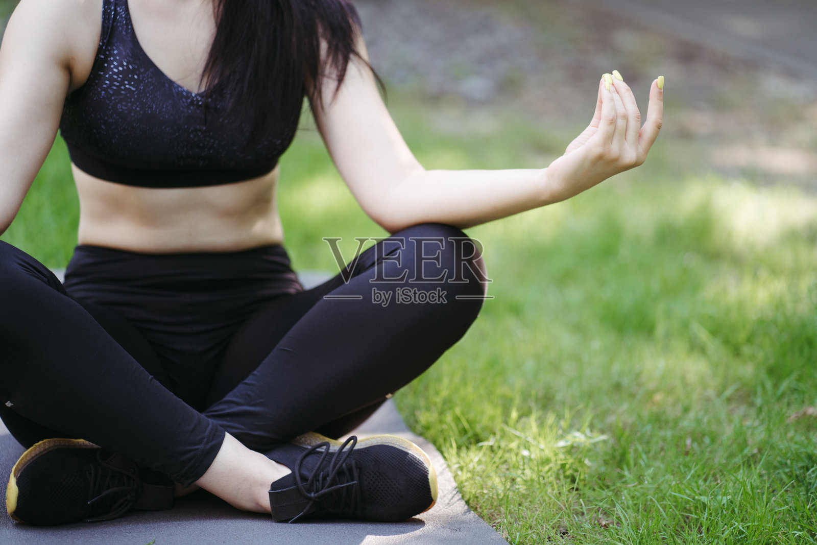 年轻女子在户外垫子上做瑜伽冥想照片摄影图片