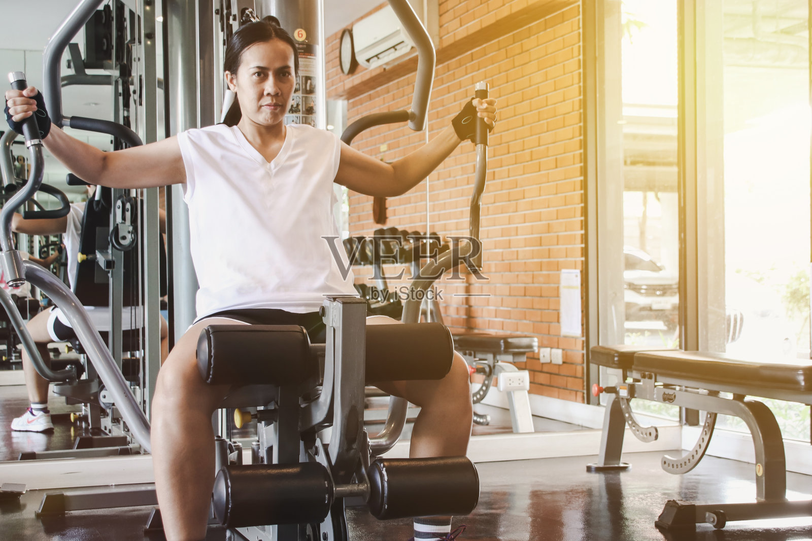 在健身房的机器上锻炼。健身的概念。照片摄影图片