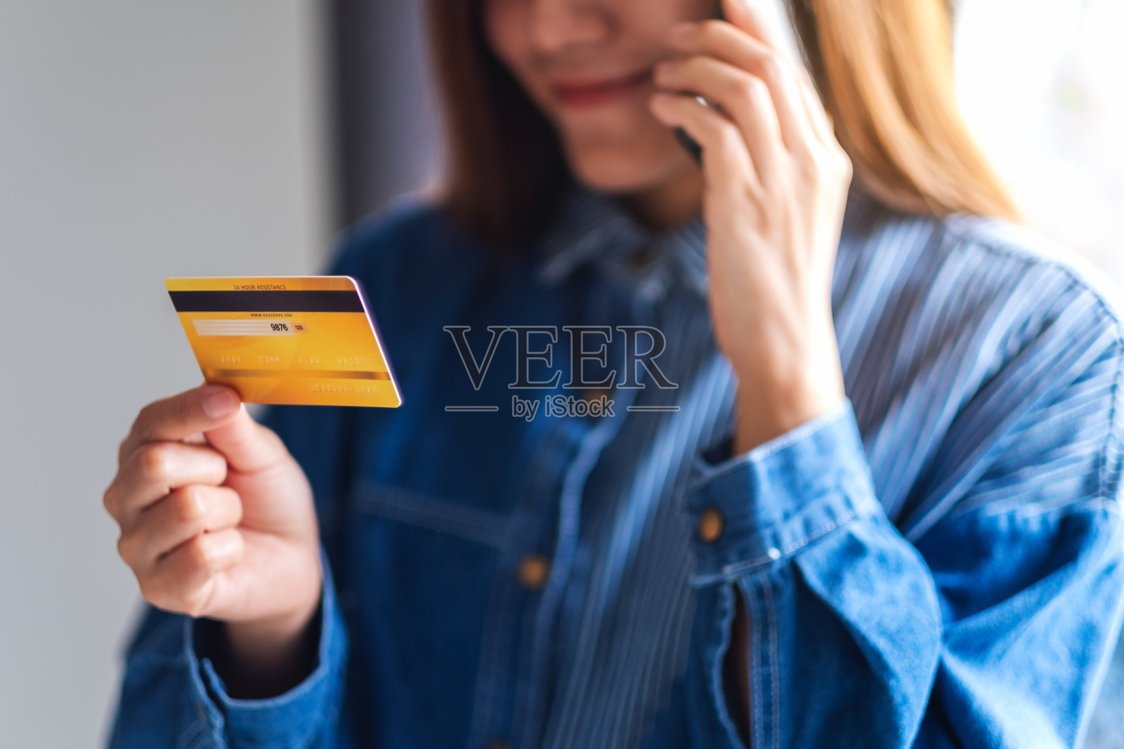 一个年轻的女人用信用卡购物和网上购物的手机照片摄影图片