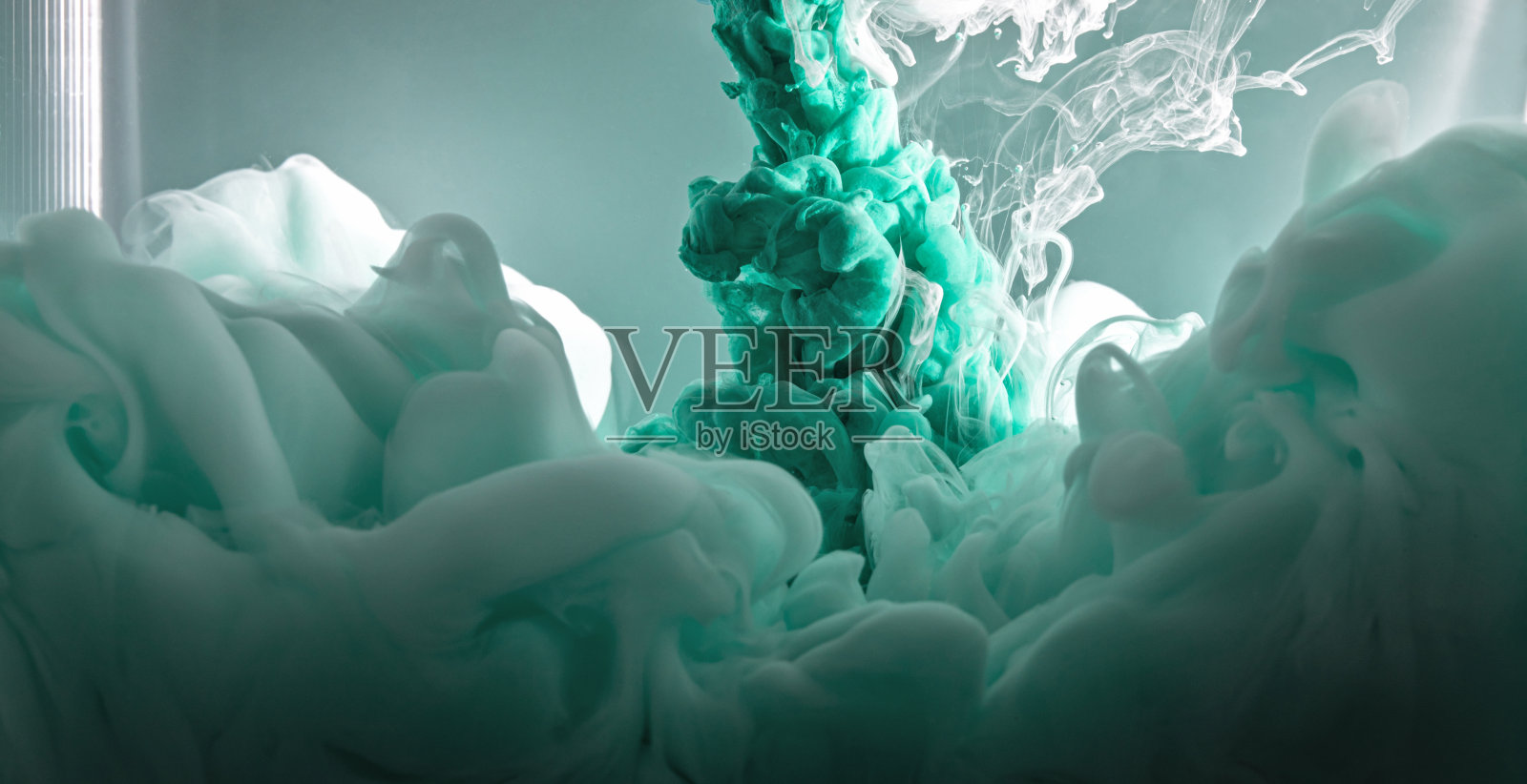 绿色和白色的丙烯酸颜料在水中。抽象的背景。照片摄影图片