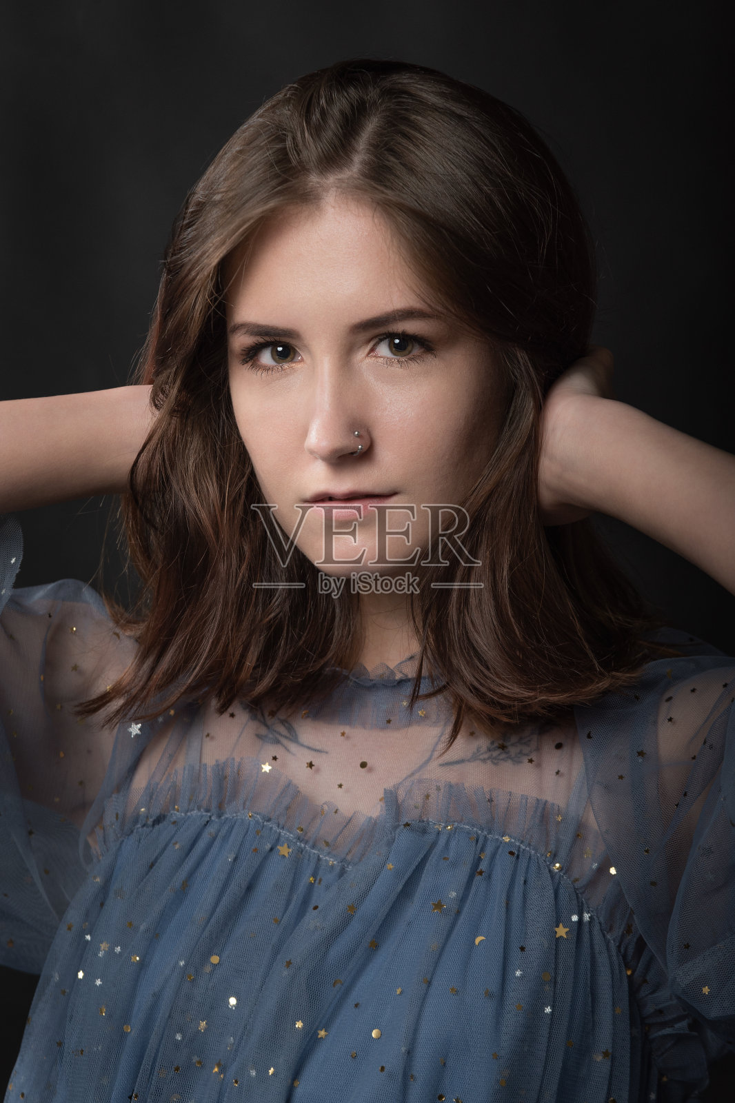 美丽的黑发年轻女人的肖像在黑色的背景照片摄影图片