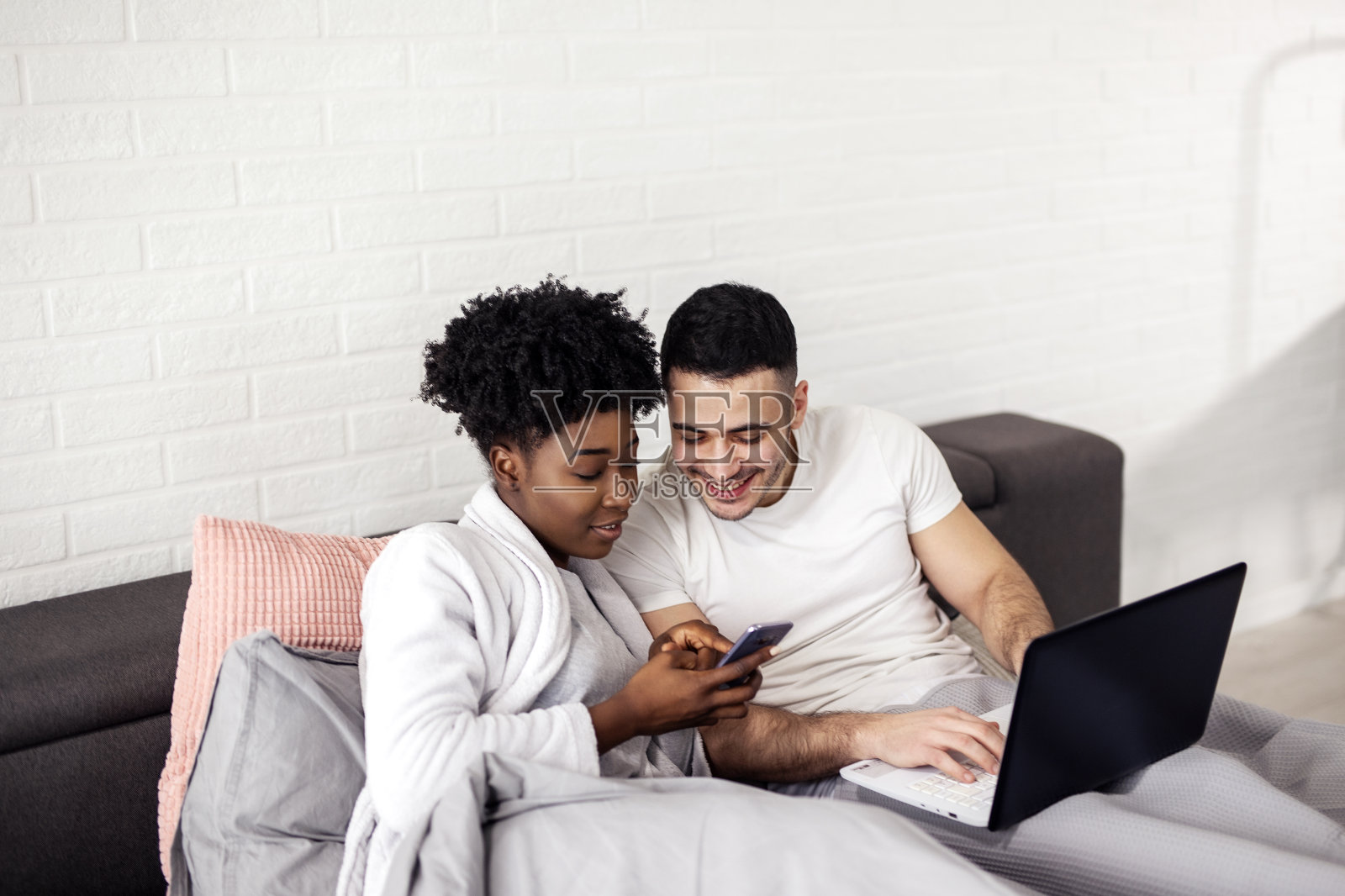 多民族夫妇林床使用笔记本电脑清晨照片摄影图片