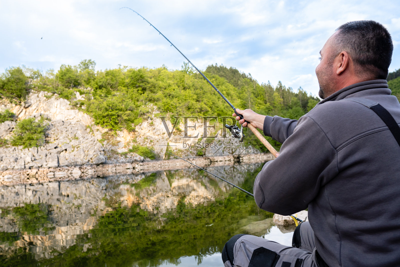 渔夫正拿着鱼竿照片摄影图片