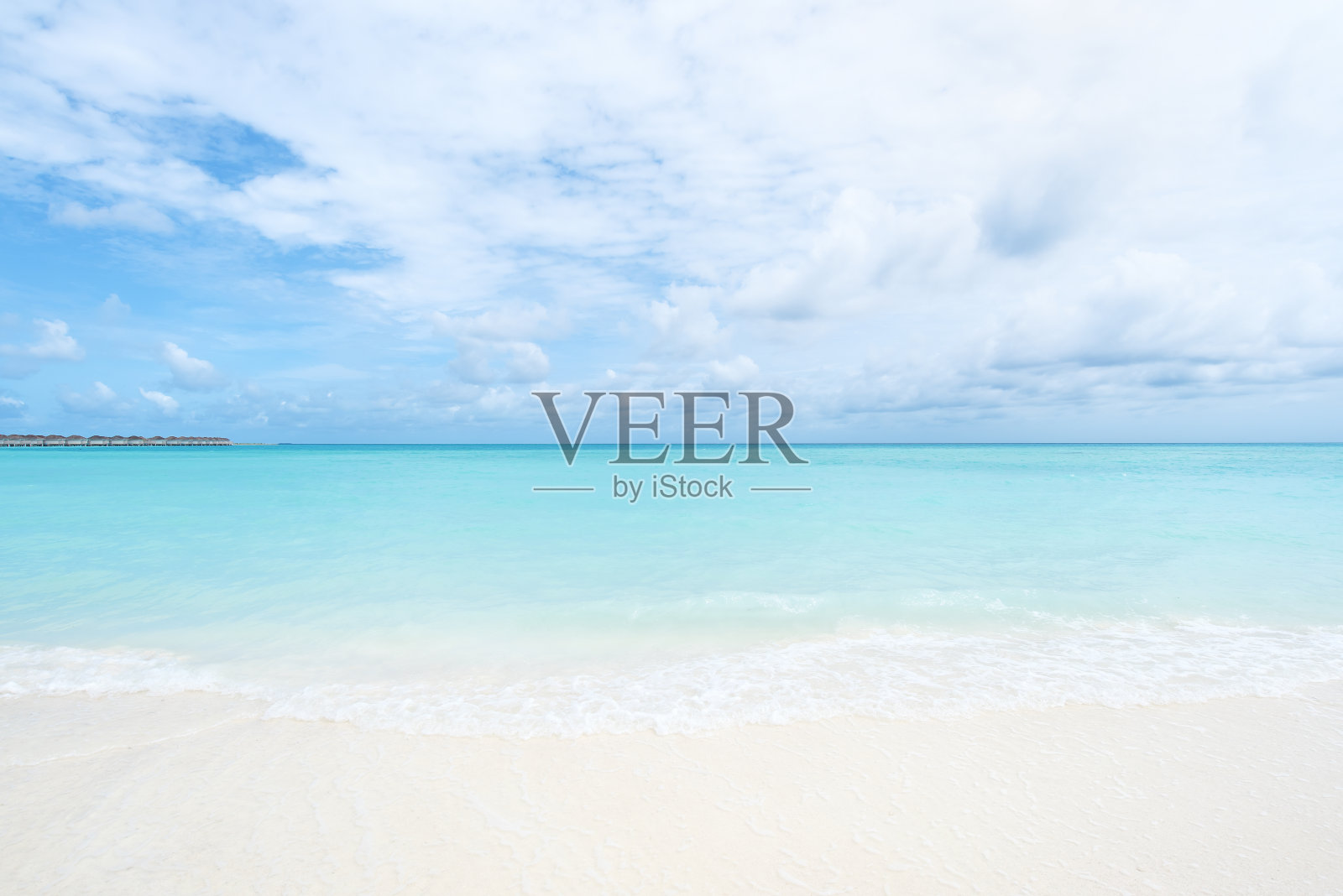 美丽的海滩，碧波荡漾的大海和白云密布的天空照片摄影图片