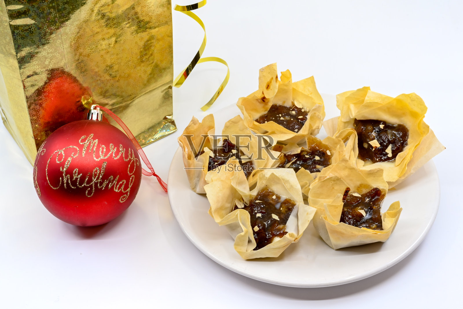 百果馅饼的形式，与圣诞小玩意和礼物袋的酥皮包裹照片摄影图片
