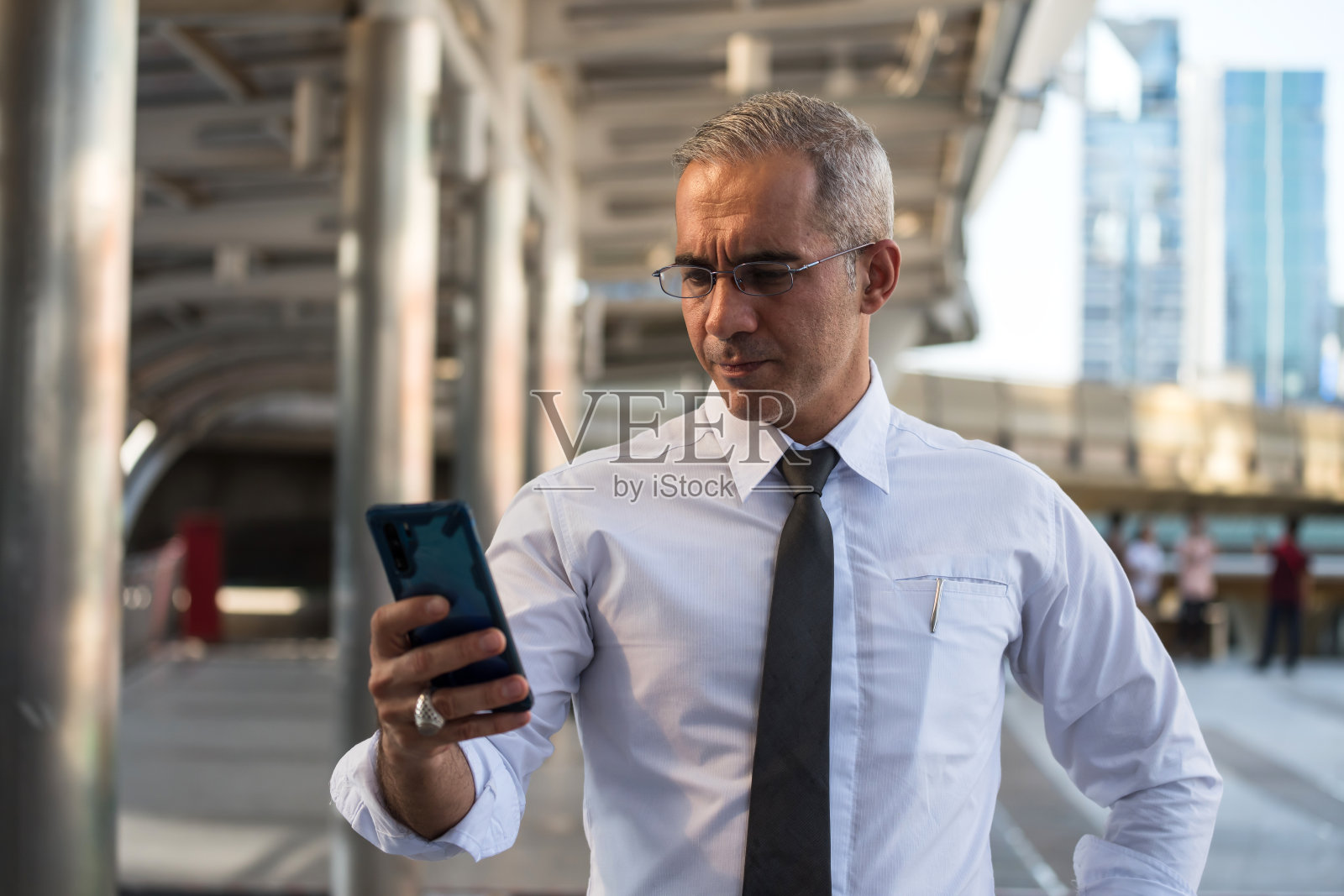 高级商务人士在户外使用智能手机照片摄影图片