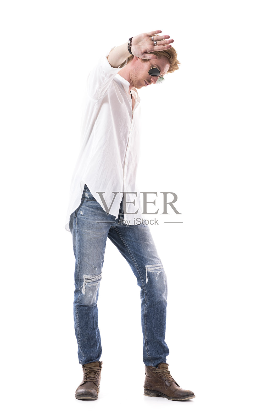 年轻时髦的男人不高兴时用手跟人说话或停下手的手势向下看。照片摄影图片