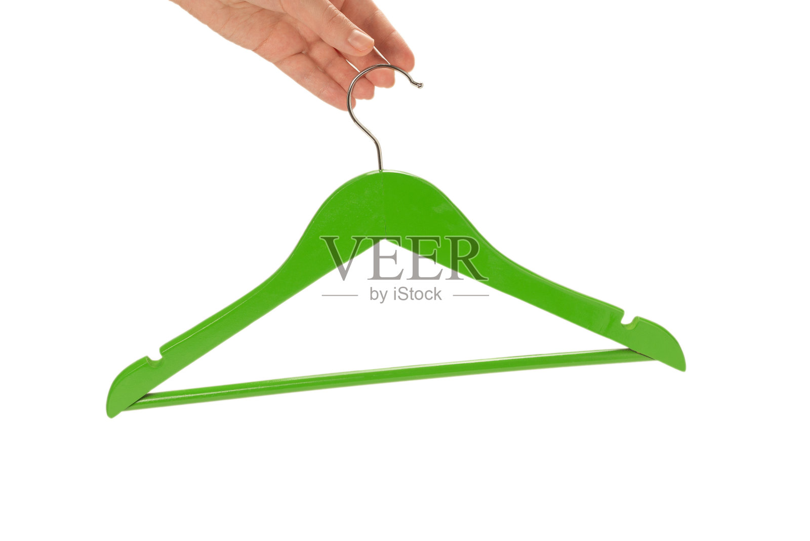 绿色衣架在女人手上孤立在白色照片摄影图片