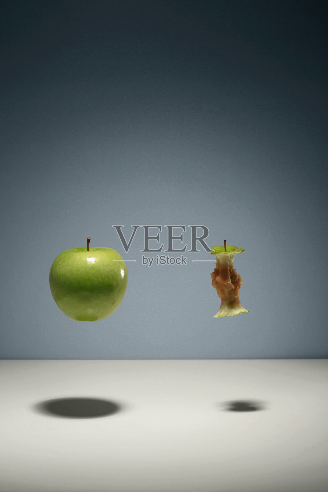 青苹果和苹果核漂浮在空中照片摄影图片