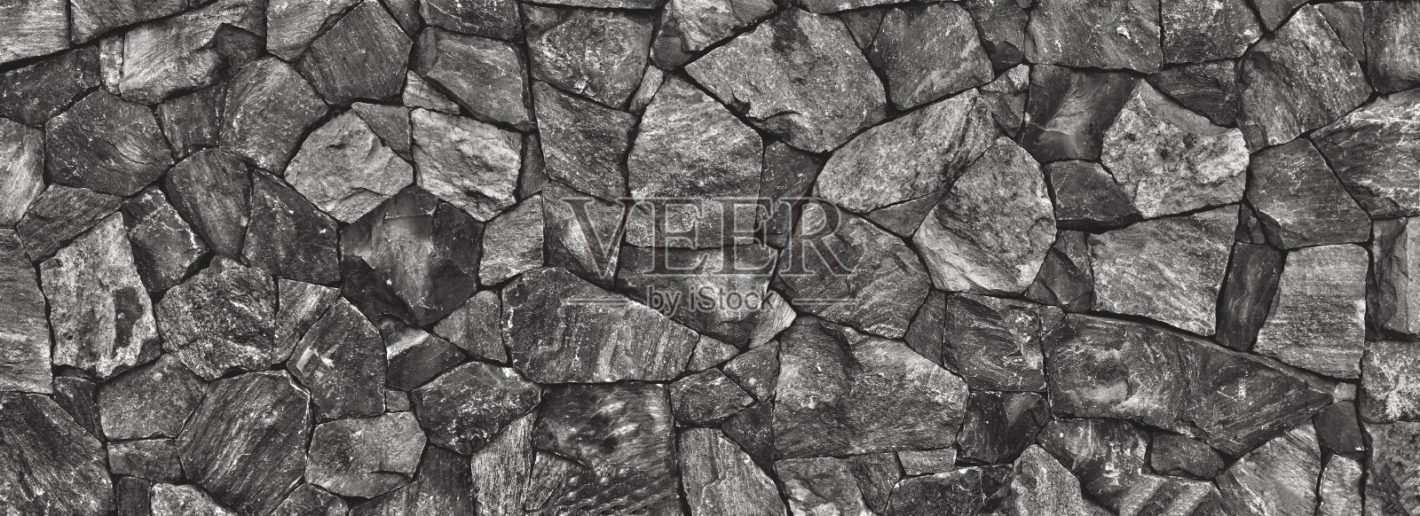 古老的石墙抽象的黑色背景和纹理。照片摄影图片