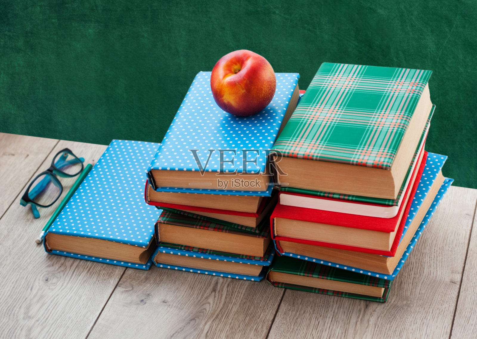 回到学校，木桌上堆满了彩色封皮的书照片摄影图片