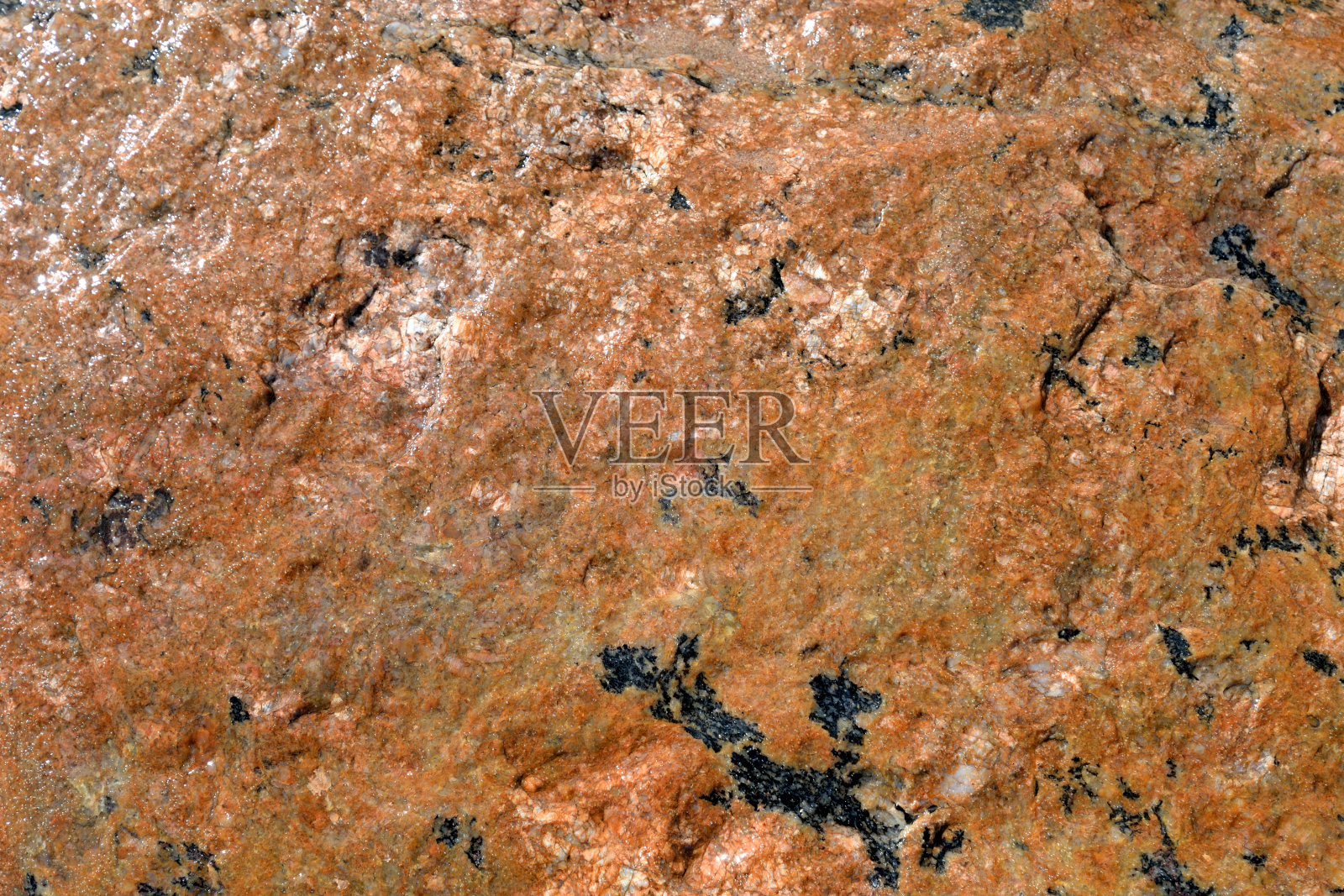 红色花岗岩的背景。照片摄影图片