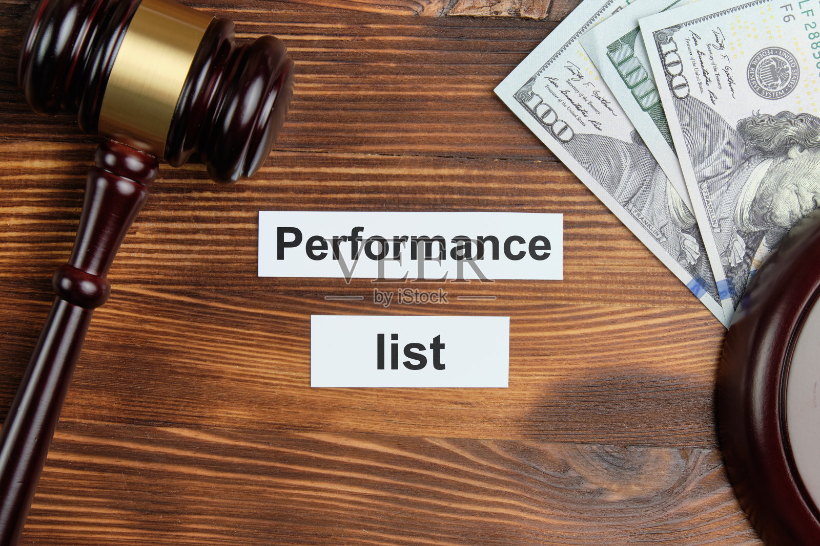 表演清单-贴纸上的题词。法官用锤子砸钱照片摄影图片