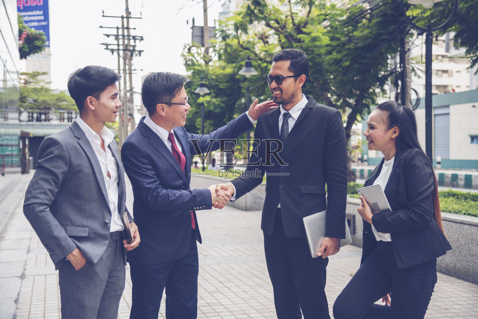 亚洲多元文化商业企业群体户外现代城市。多样性，同事，团队谈论信任的伙伴关系。咨询同事商务人士会议概念照片摄影图片