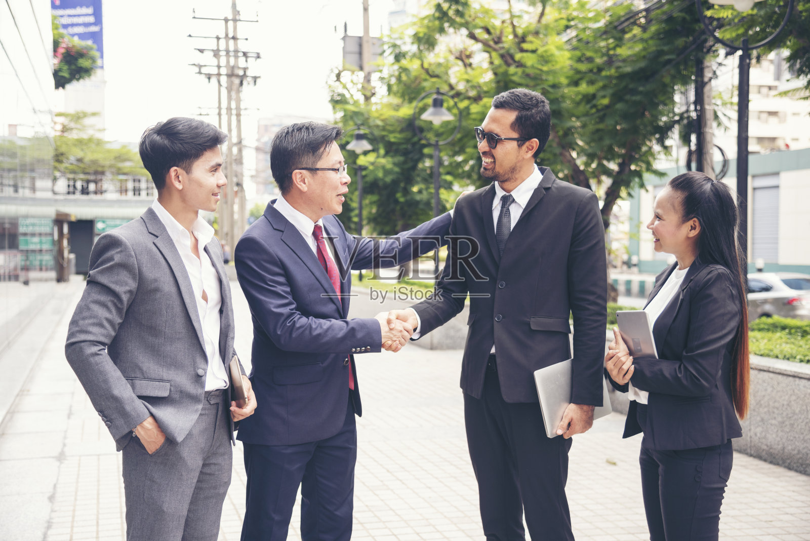 亚洲多元文化商业企业群体户外现代城市。多样性，同事，团队谈论信任的伙伴关系。咨询同事商务人士会议概念照片摄影图片