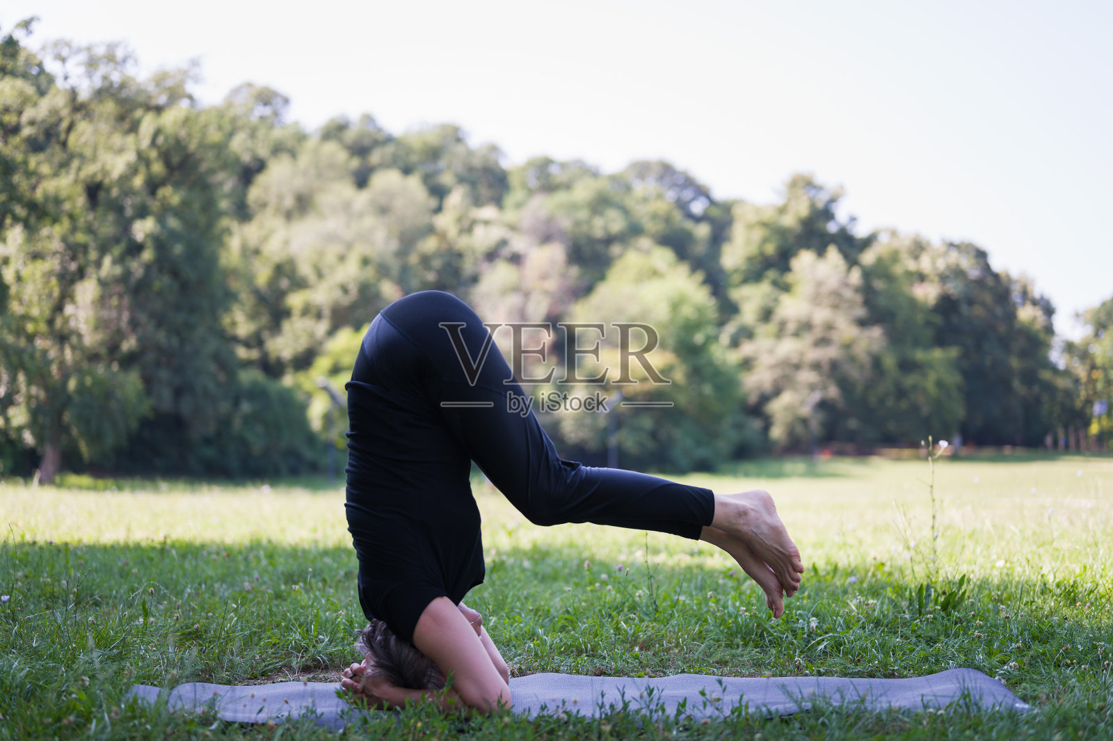 成熟的中年健康女性在户外的自然环境中练习瑜伽照片摄影图片