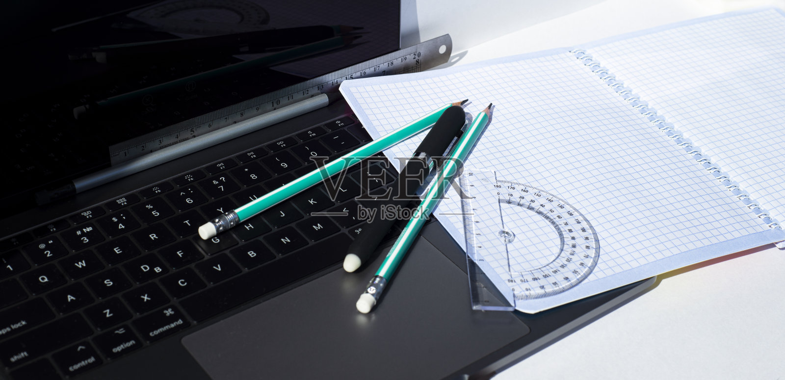 笔记本，圆珠笔，铅笔，量角器和方形笔记本。为文本复制空间。照片摄影图片