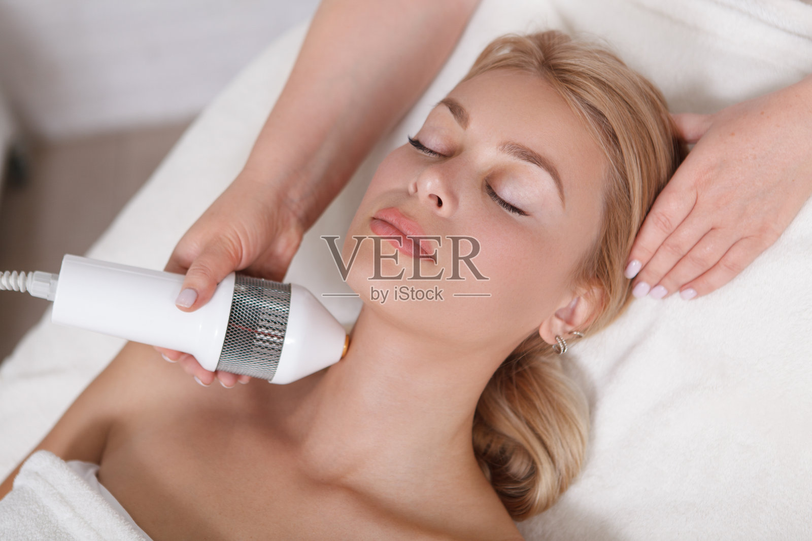 正在接受美容师面部皮肤护理的美女照片摄影图片