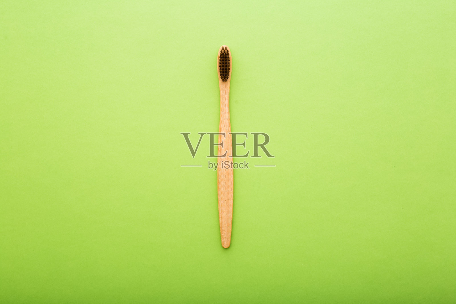 牙科保健与环保竹牙刷在绿色背景俯视图。零废物和无塑料的概念。照片摄影图片